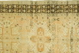 Vintage Oushak rug with chocolaty charcoal geometric border and peachy gold field.