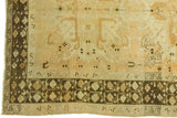 Vintage Oushak rug's chocolaty charcoal geometric border and peachy gold field.