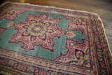 Vintage mint green Tabriz mat with central medallion and distressed pink floral pattern, 1'7