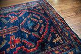 Visible pile and spirited geometric patterns on a vintage indigo blue Lilihan rug corner.