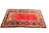 Deep rust vintage Turkish prayer rug with geometric borders. Measures 3'6