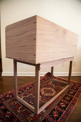 Rear corner view of the walnut sidecar, showing its precision joinery and smooth grain.