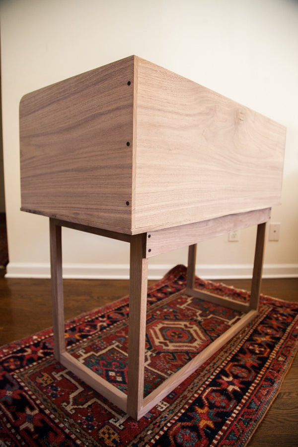 Rear corner view of the walnut sidecar, showing its precision joinery and smooth grain.