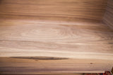 Swirling grain patterns of the smooth, unfinished walnut inside the handmade sidecar.