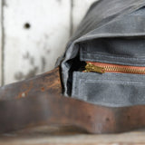 Peg and Awl Tote Bag: slate waxed canvas, brass zipper, brown leather strap.
