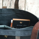 Inside the slate tote bag, a green gingham pocket holds a small chalkboard.