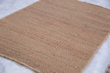 Hand-woven pure jute rug in a textured wheat tone.