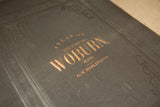 Gilt title and blind-stamped details on the cover of the antique Woburn atlas.
